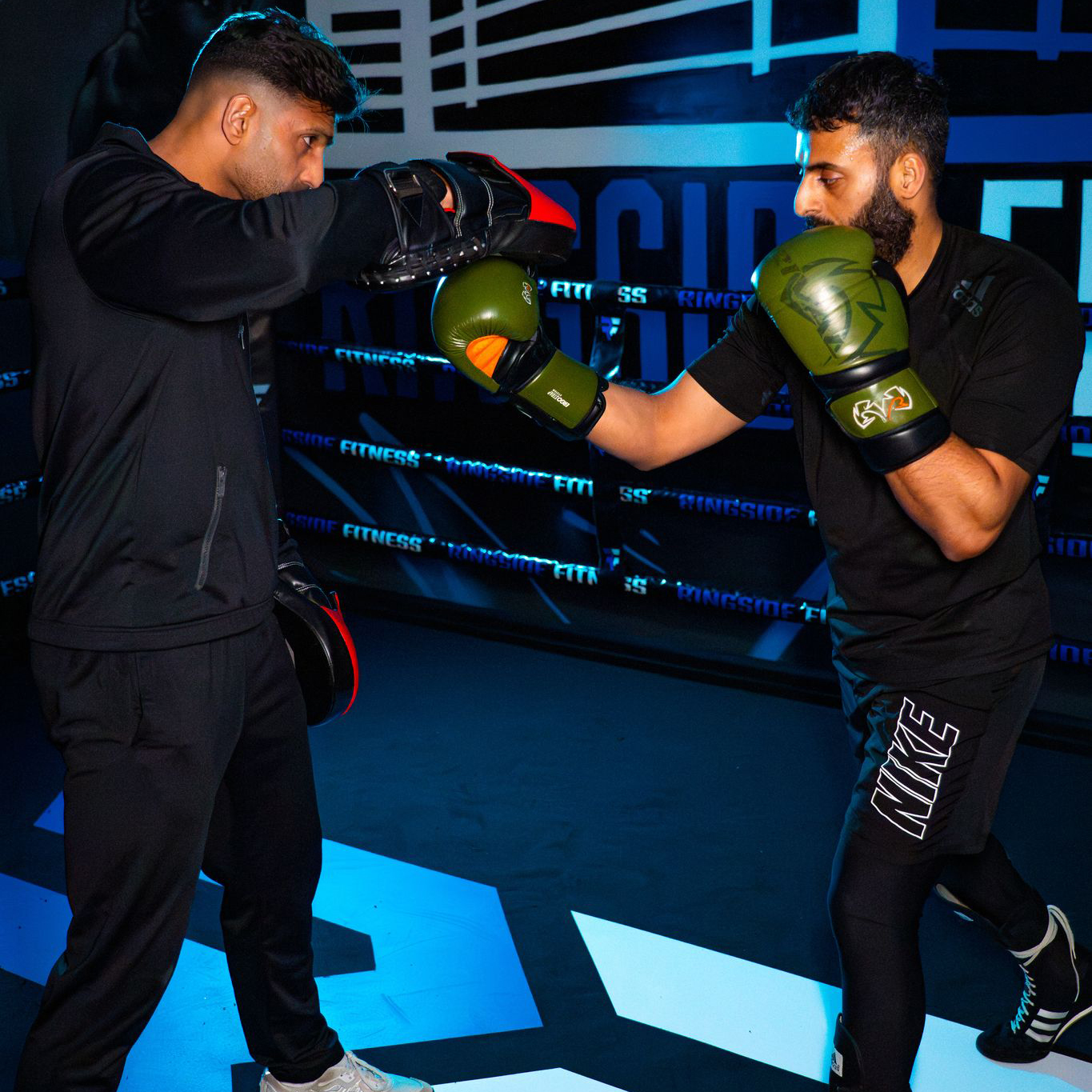 Coach and member working the pads at Ringside Fitness