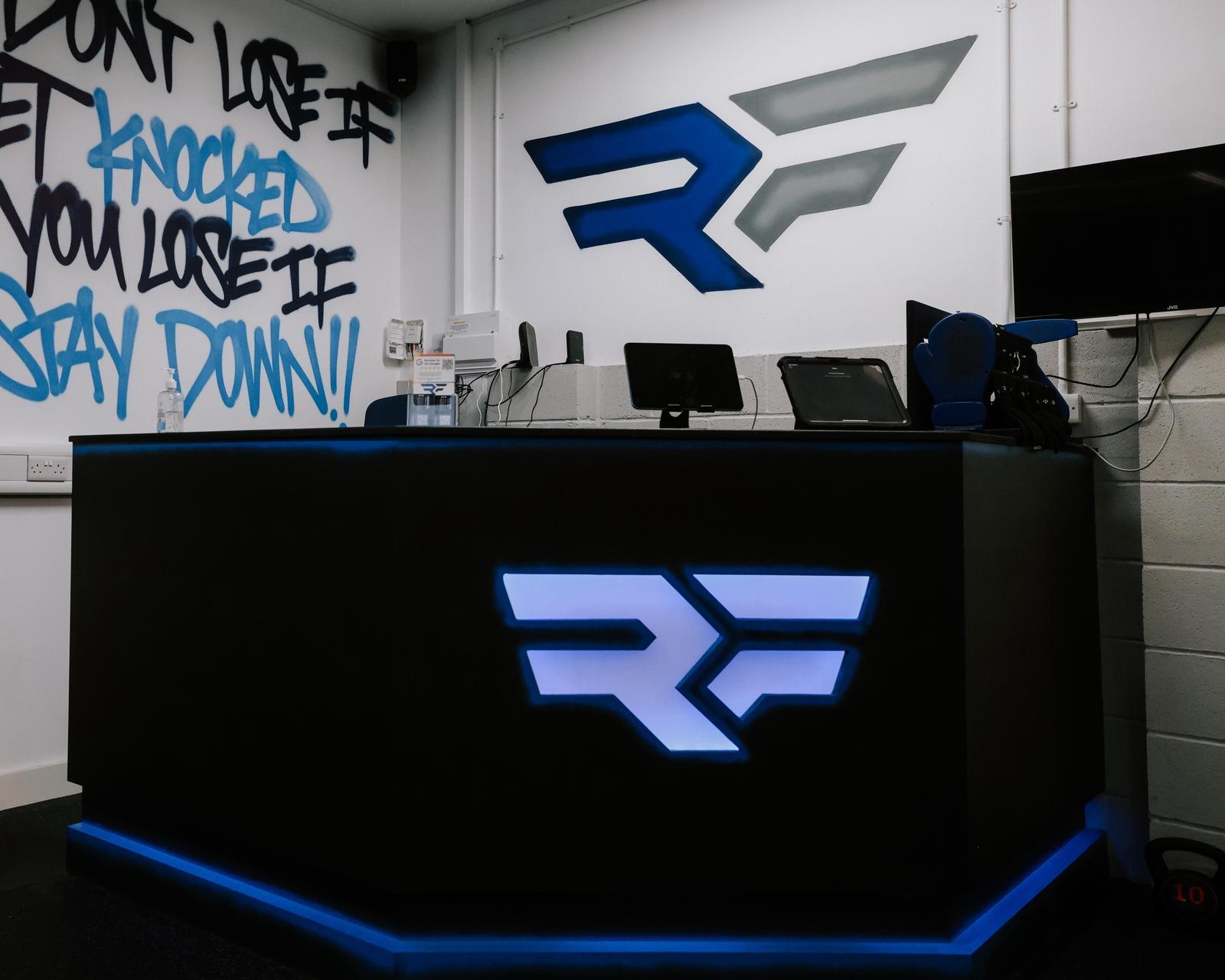 Reception desk with illuminated Ringside Fitness logo